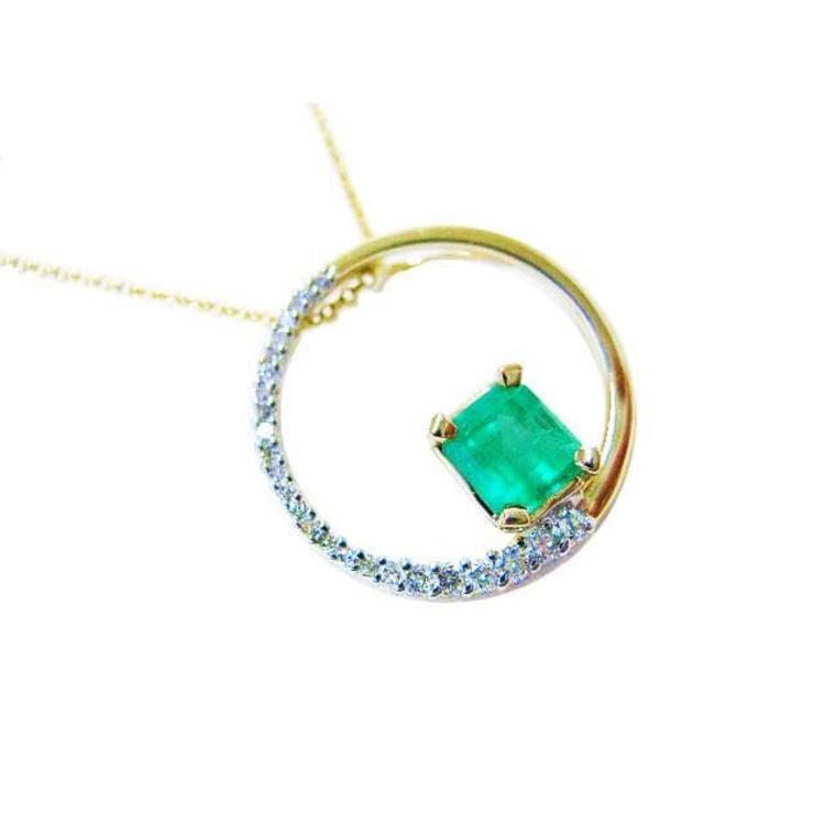 The circle of life with a genuine Colombian emerald pendant necklace, topside view, half diamonds and half gold.