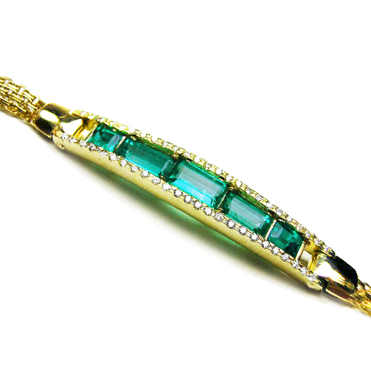Gold bracelet with five high qualities natural colombian emeralds and side diamonds on a white background.