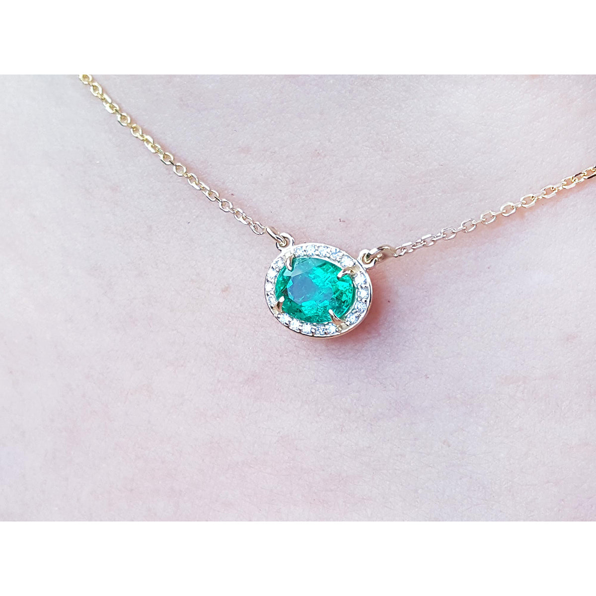 Halo natural diamond Emerald necklaces for sale from Muzo mines Colombia, crafted in 14k yellow gold