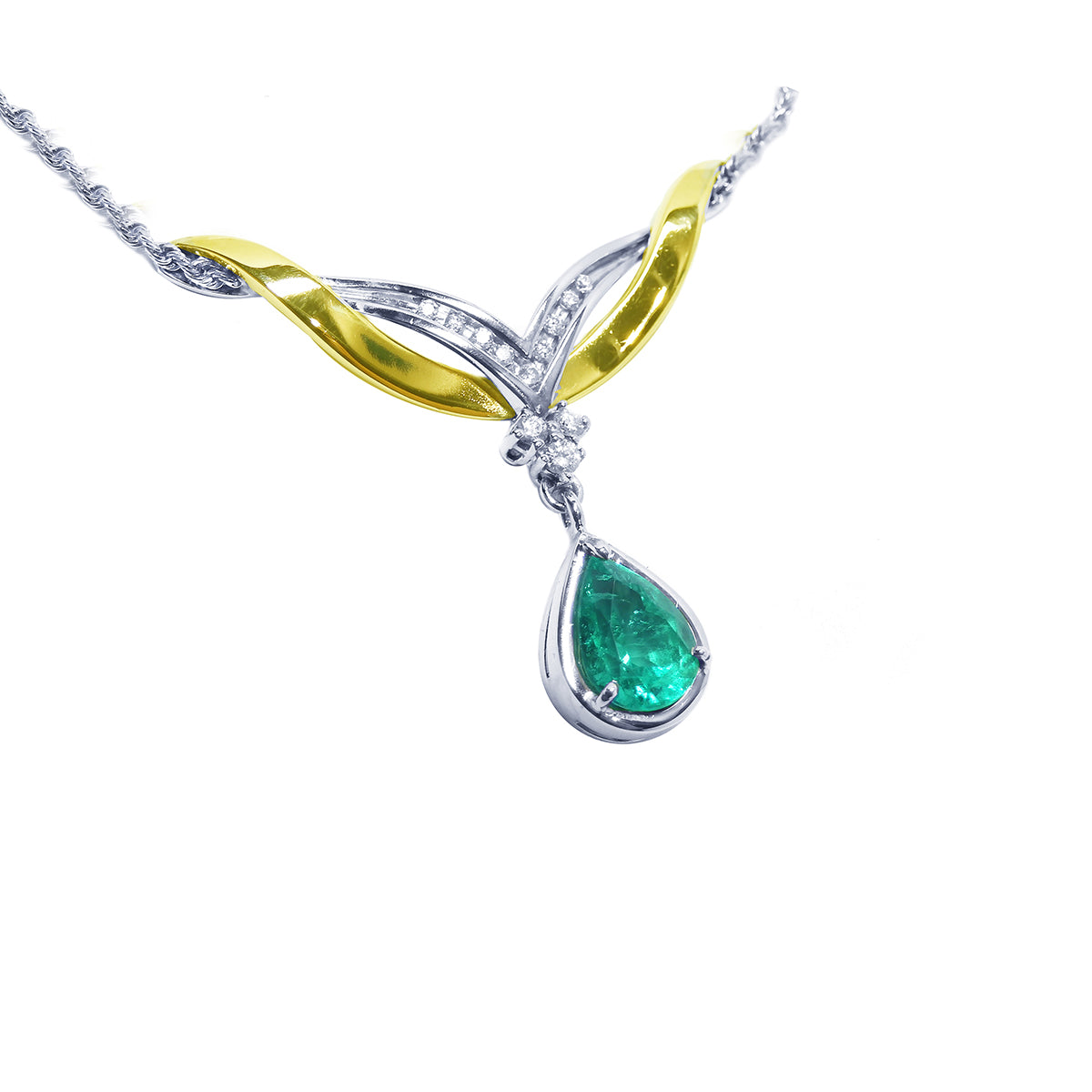 A close sight of a dangling teardrop real Colombian emerald necklace, made in 14k yellow and white gold