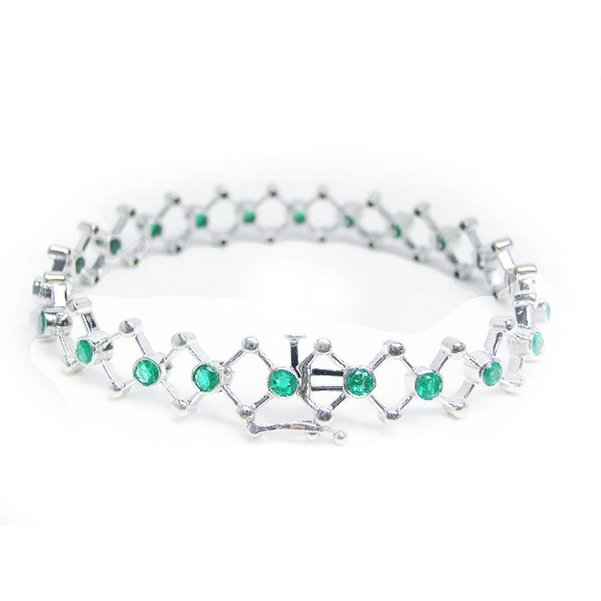 A clos-up view of a closure system on a white gold emerald bracelet on a white background.