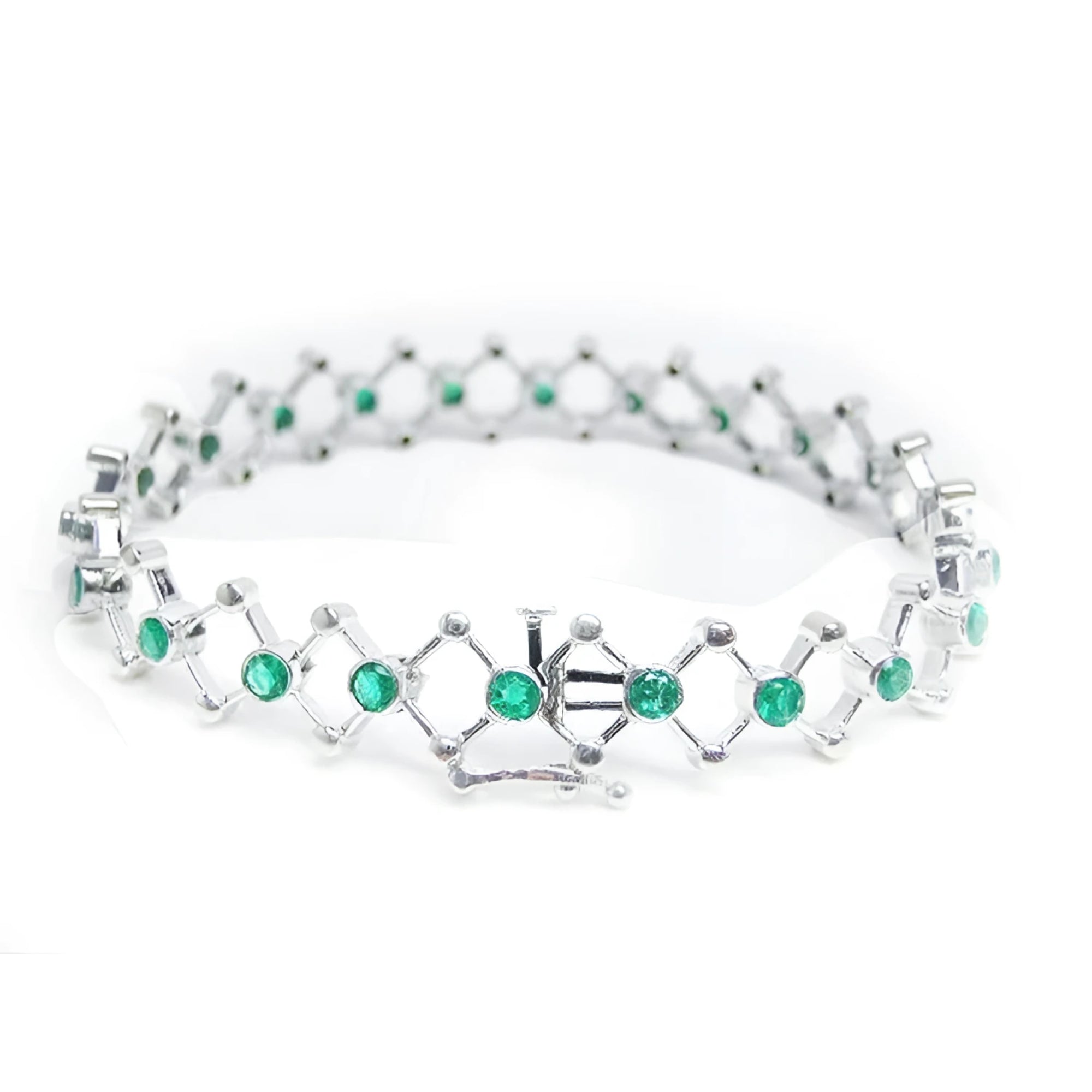 14K white gold bracelet with round Colombian emeralds bezel-set in diamond-shaped links.
