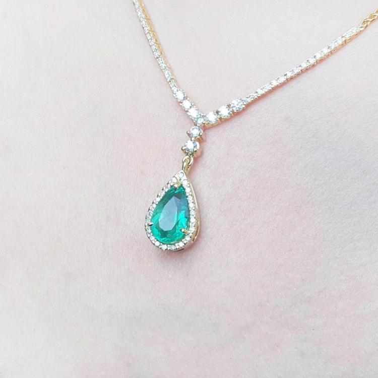 close view of a genuine emerald necklace jewelry high quality pear cut natural sourced from the Colombian Muzo mine