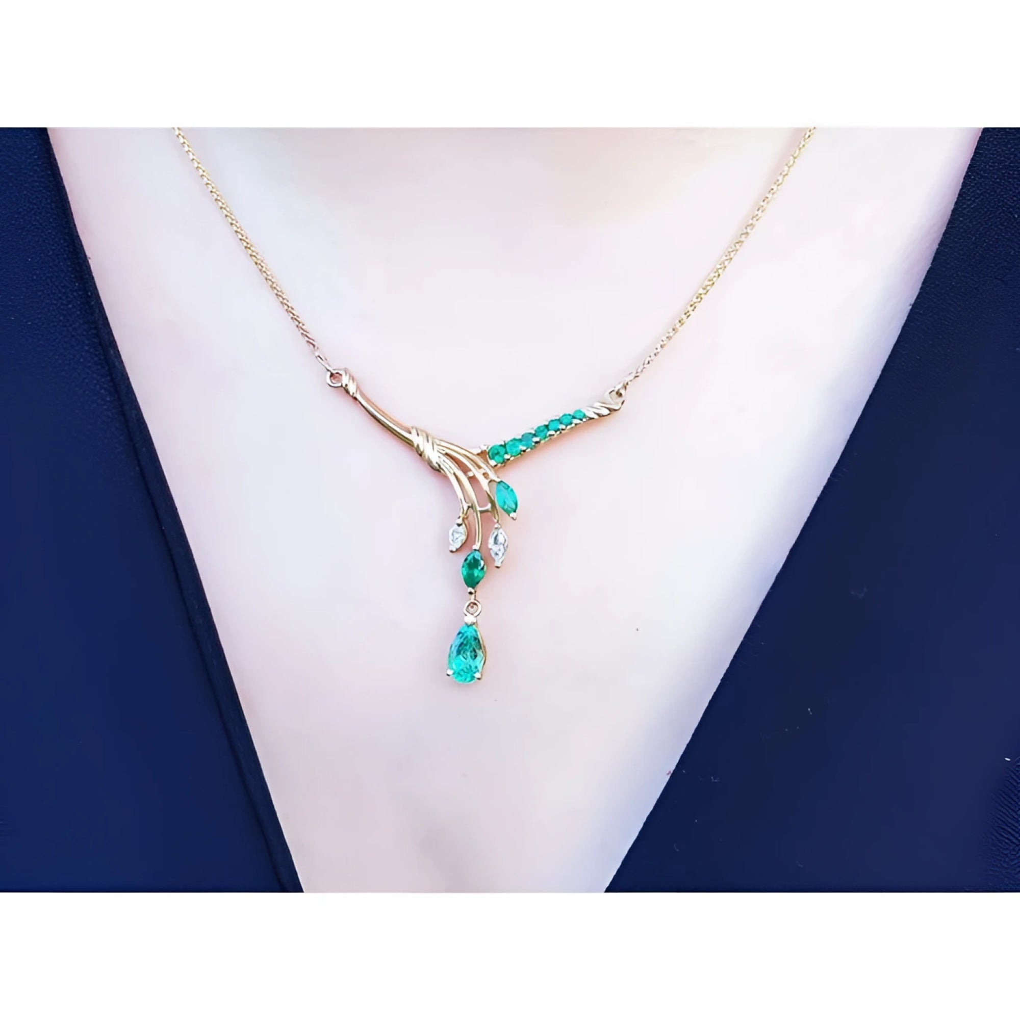 14K yellow gold necklace with marquise and pear-shaped Colombian emeralds and diamonds.
