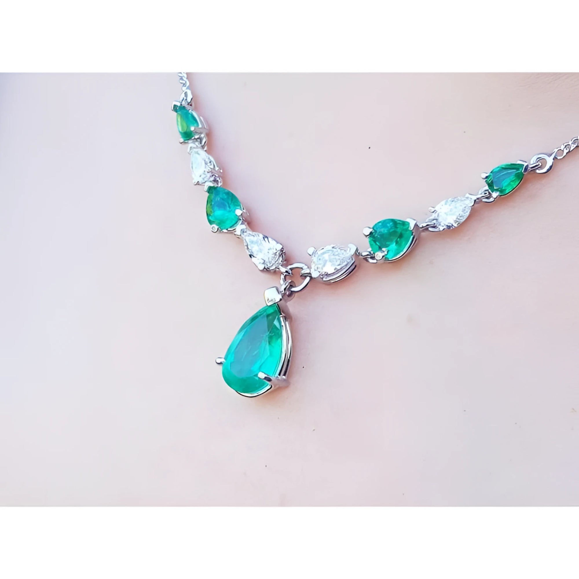 Pear-shaped emerald and diamond necklace in 14k white gold, featuring a large emerald drop.
