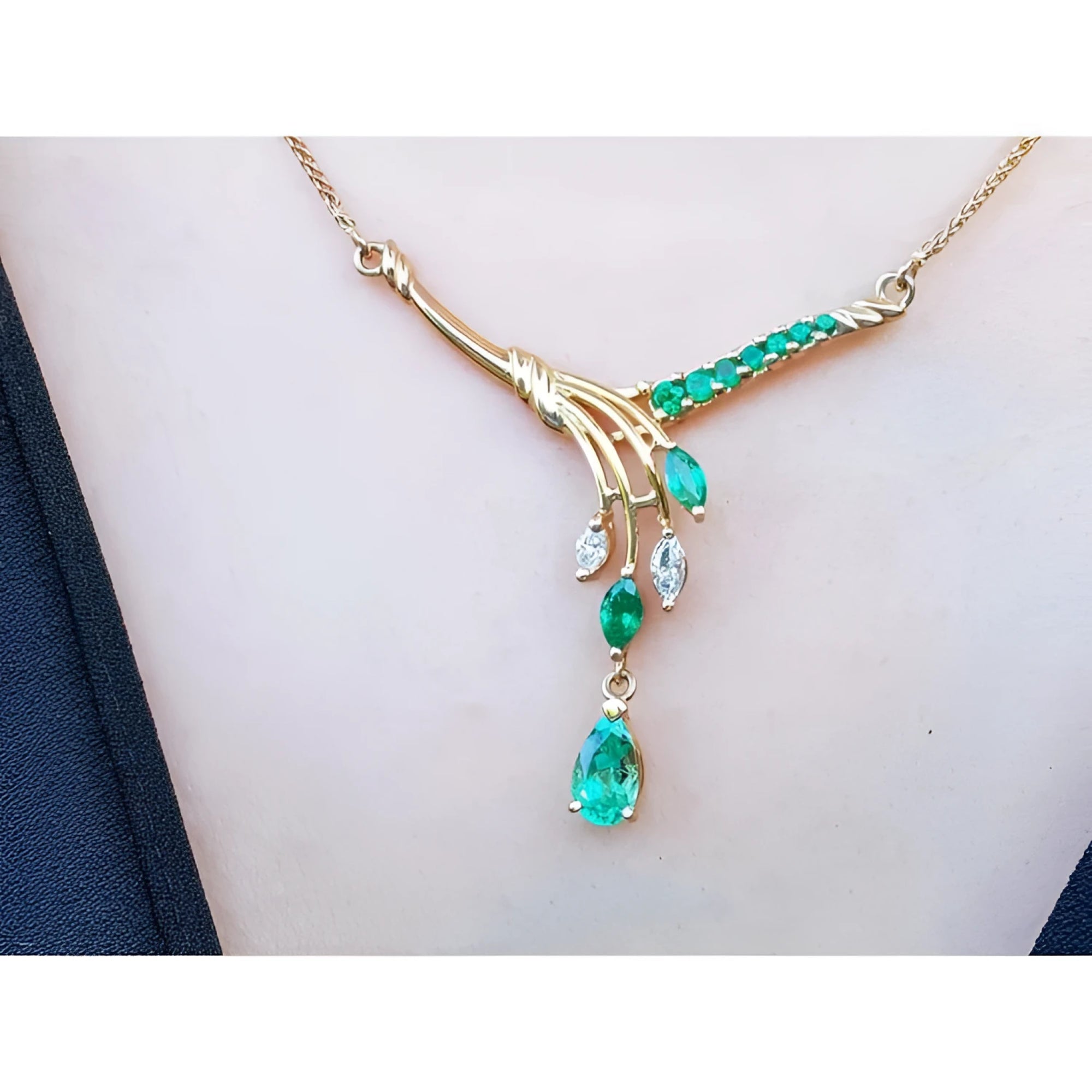 14K yellow gold necklace with marquise and pear shaped Colombian emeralds and diamonds.