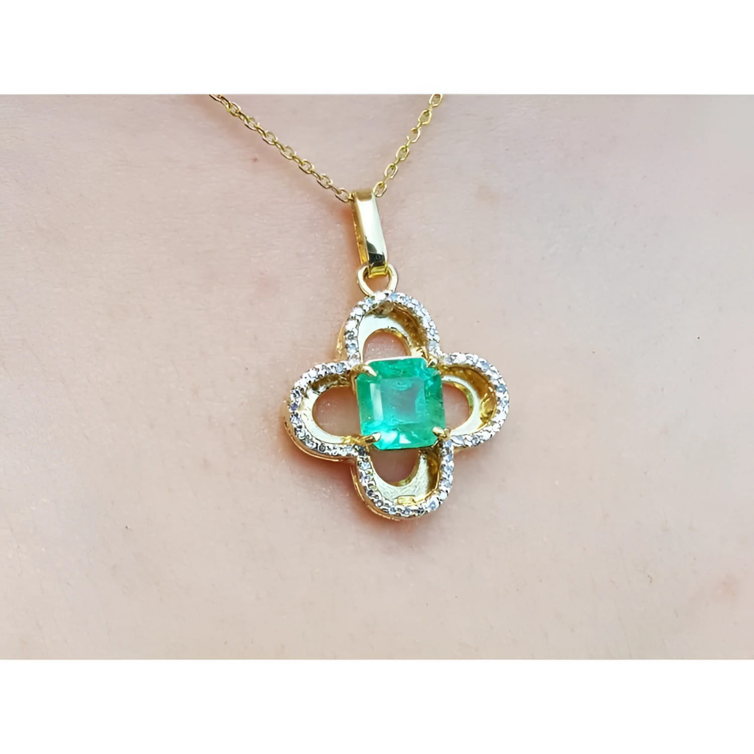 14K gold clover pendant with a square Colombian emerald and natural diamonds on a chain.