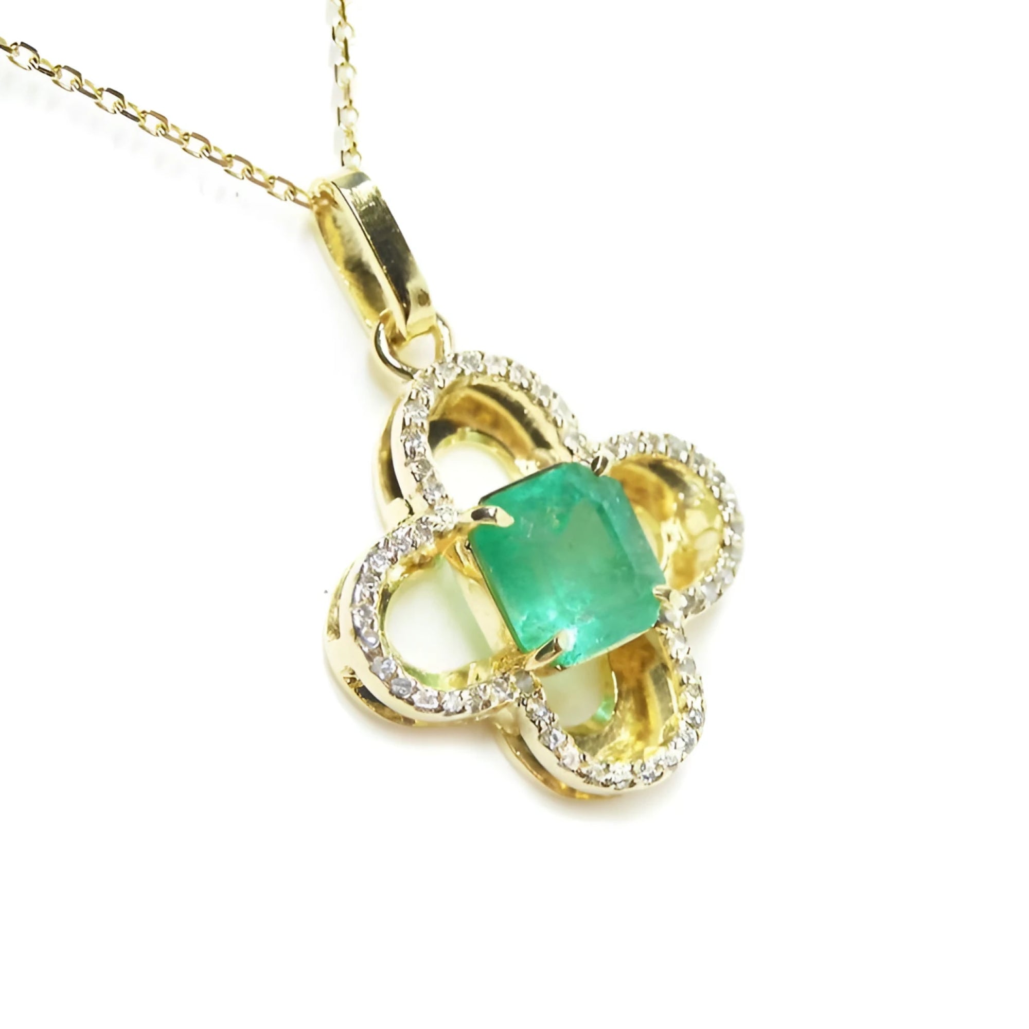 A four-leave clover design natural colombian emerald and diamonds pendant in 14k yellow gold.