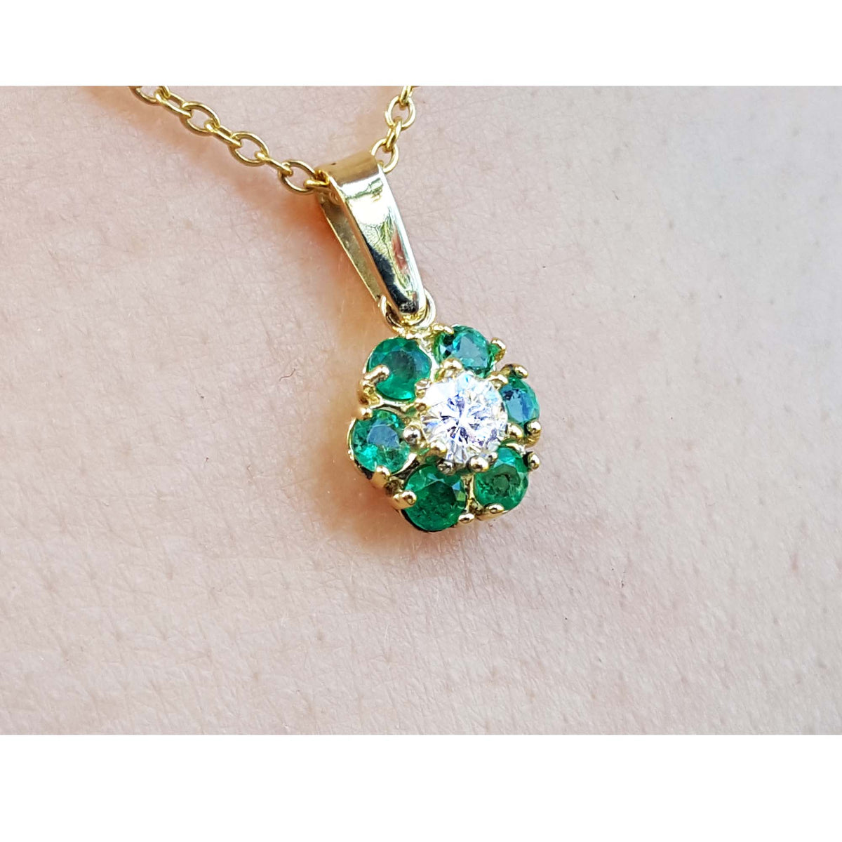 Natural colombian emeralds and diamond cluster pendant necklace in 18k yellow gold.