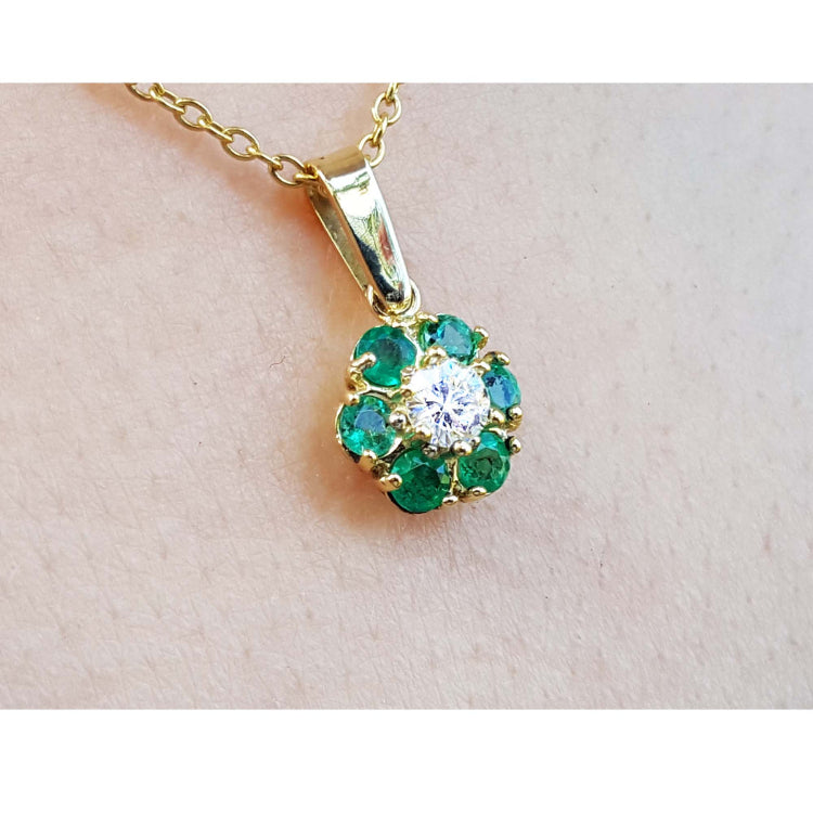 Natural colombian emeralds and diamond cluster pendant necklace in 18k yellow gold.