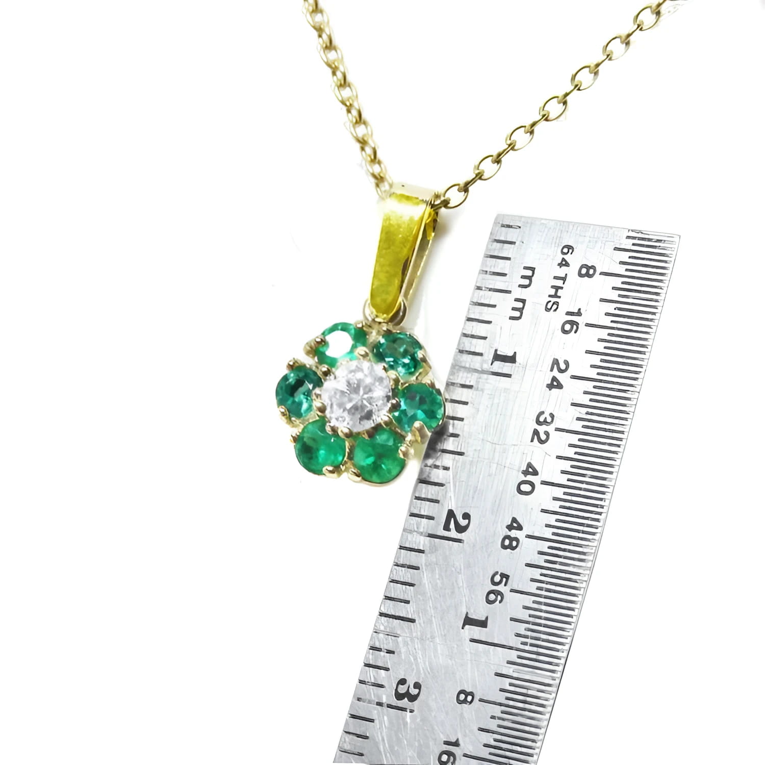 18K yellow gold cluster pendant with Colombian emeralds and a center diamond, shown with a ruler.