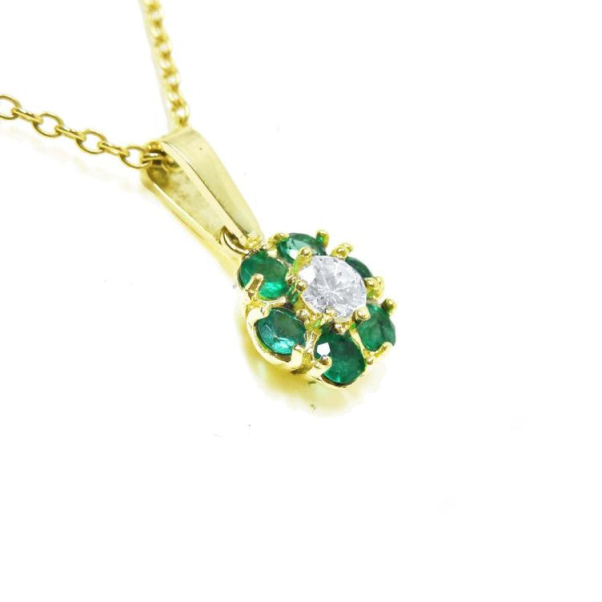 18K yellow gold cluster pendant with deep green emeralds and a brilliant center diamond.
