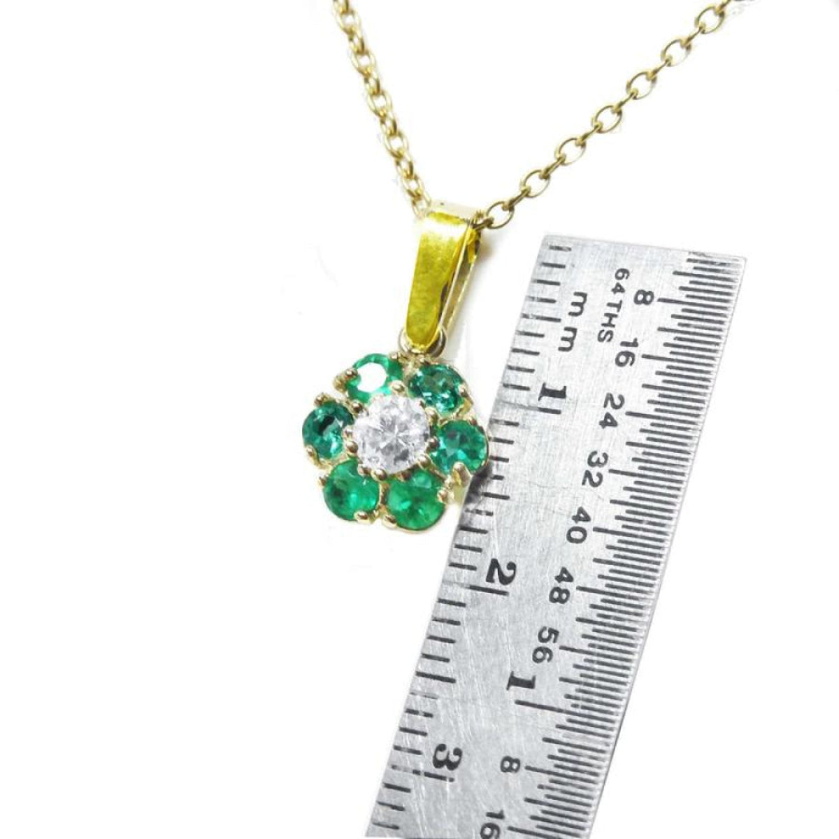 18K yellow gold cluster pendant with Colombian emeralds and a center diamond, shown with a ruler.