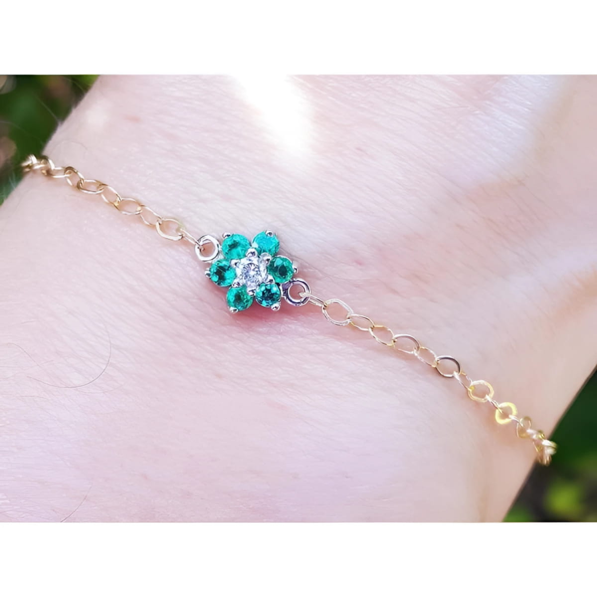 Gold bracelet featuring a natural Colombian emerald cluster in a flower shape with a diamond at the center.