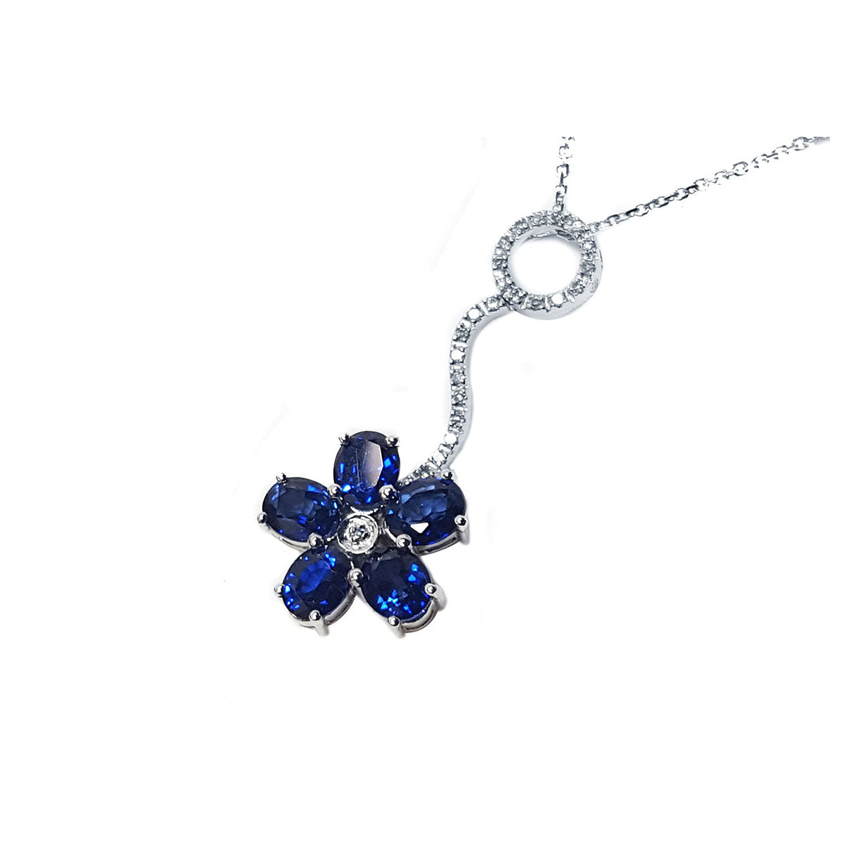 Left side of a cluster of natural sapphires pendant white gold necklace top view