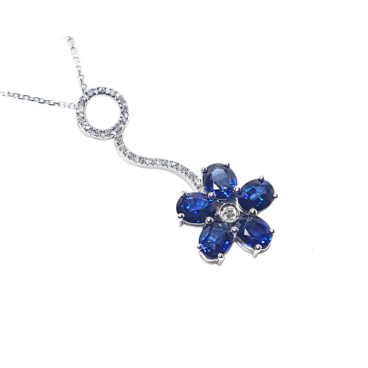 Right side top view of a cluster of natural sapphires pendant white gold necklace