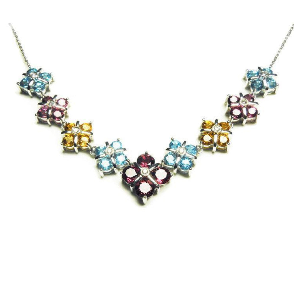 18K white gold necklace with tri-colored topaz X-cluster links and a diamond accent.