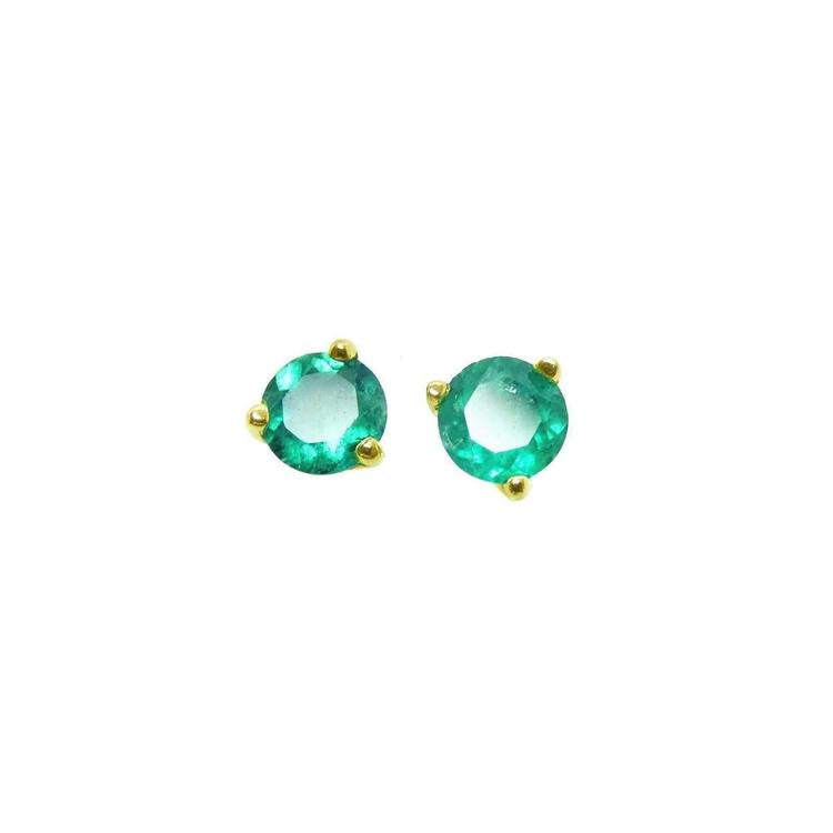 A pair of cocktail emerald stud earrings with a round cut design, set in 14K yellow gold.