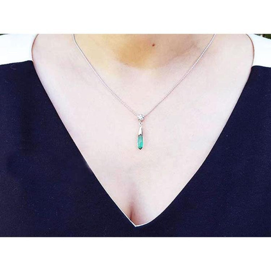 Colombian emerald briolette necklace with a diamond slider on a 14K white gold chain, worn on a woman's neck.