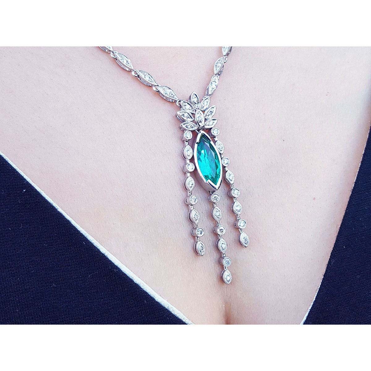 On a woman&#39;s collar a marquise necklace 2.12 carats Colombian emerald and diamonds 14K white gold