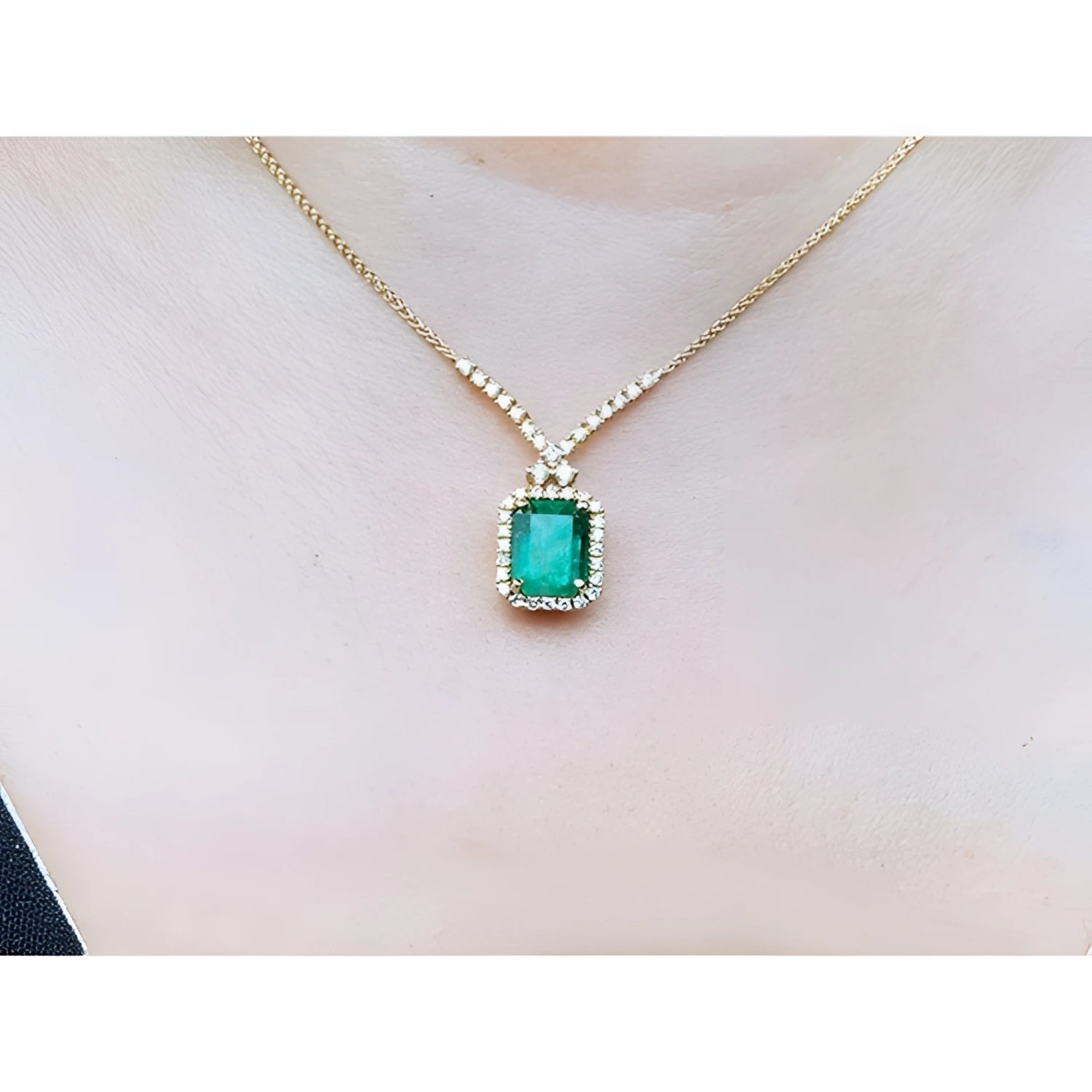 3.43 ct emerald halo necklace with natural diamonds on a 14K yellow gold chain.