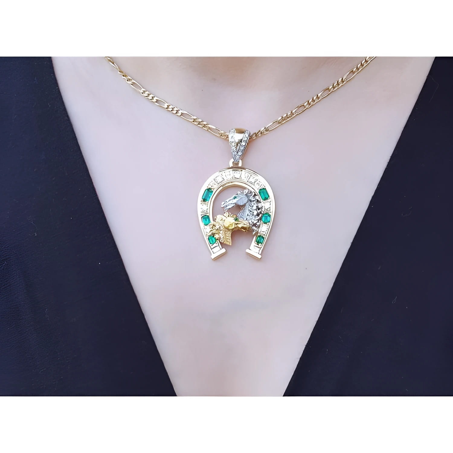 18K yellow gold horseshoe pendant with emeralds, diamonds, and horse head design on a necklace.
