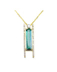 14K yellow gold necklace with a baguette-cut emerald, accent diamonds, and a sliding tube bail flanked by vertical rows of diamonds, suspended from a delicate gold chain.