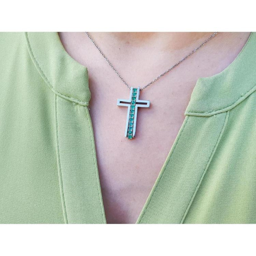 14K white gold cross pendant with round-cut Colombian emeralds on a delicate chain.