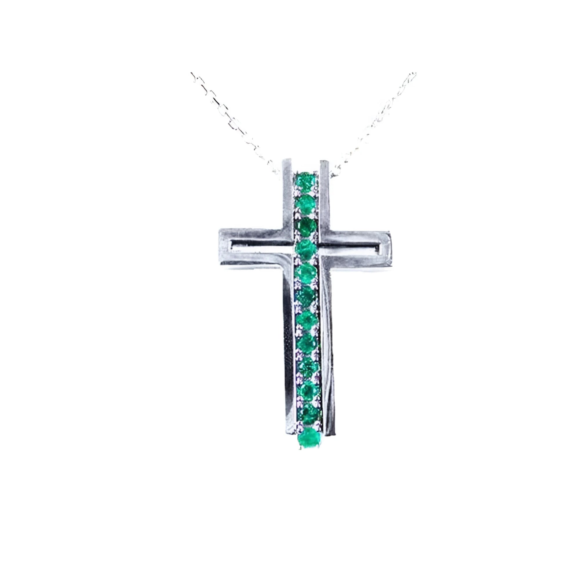 14K white gold cross pendant with a vertical row of round cut Colombian emeralds.