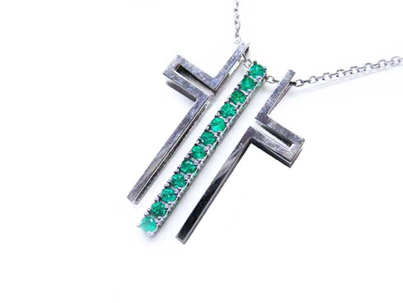 White gold necklace with round emeralds on a white background.