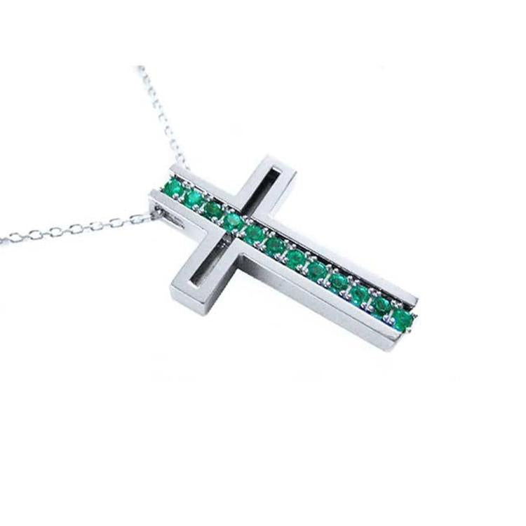 A cross-shaped pendant necklace with round cut emeralds prong set in 14K white gold.