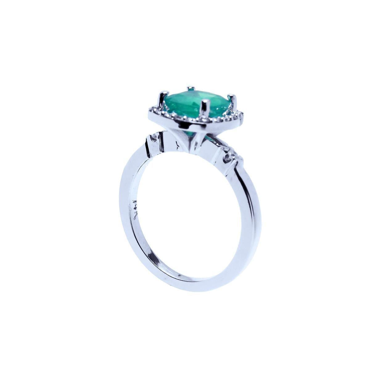 This white gold emerald ring shows the top cushion cut setting and band on a half side position.