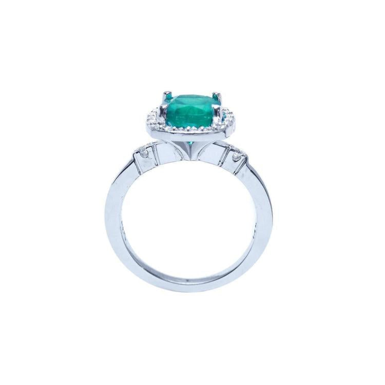 1.71 ct Colombian emerald cushion cut ring with diamond halo in 14K white gold.
