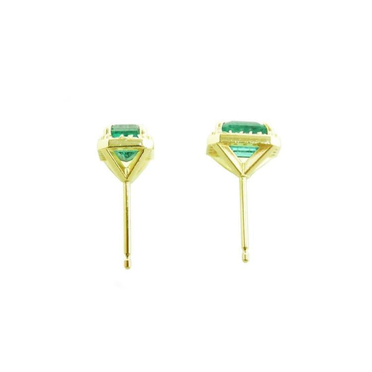 1.41 ct. natural Colombian emerald halo stud earrings in 14k yellow gold.