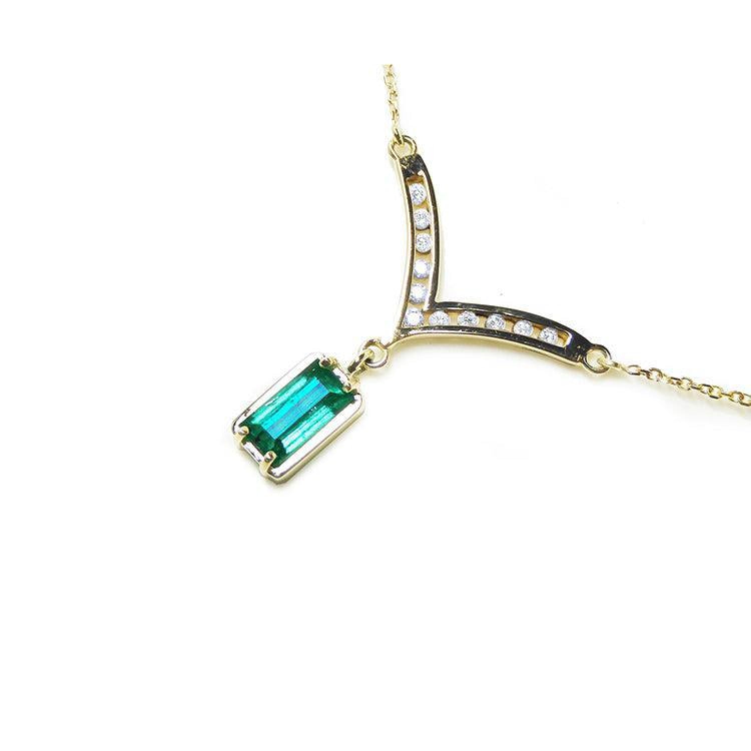 14K yellow gold necklace with a baguette-cut Colombian emerald and diamond-studded curved V pendant.