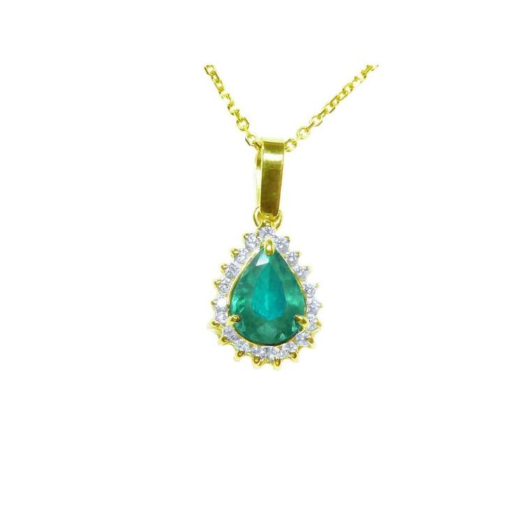 Gold pendant with a natural teardrop colombian emerald on a topside position view.