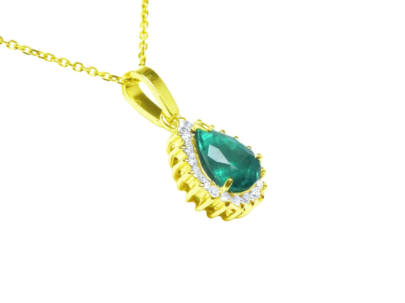 A yellow gold pendant with a teardrop natural colombian emerald accented by a halo diamond, displaying its right-side profile.