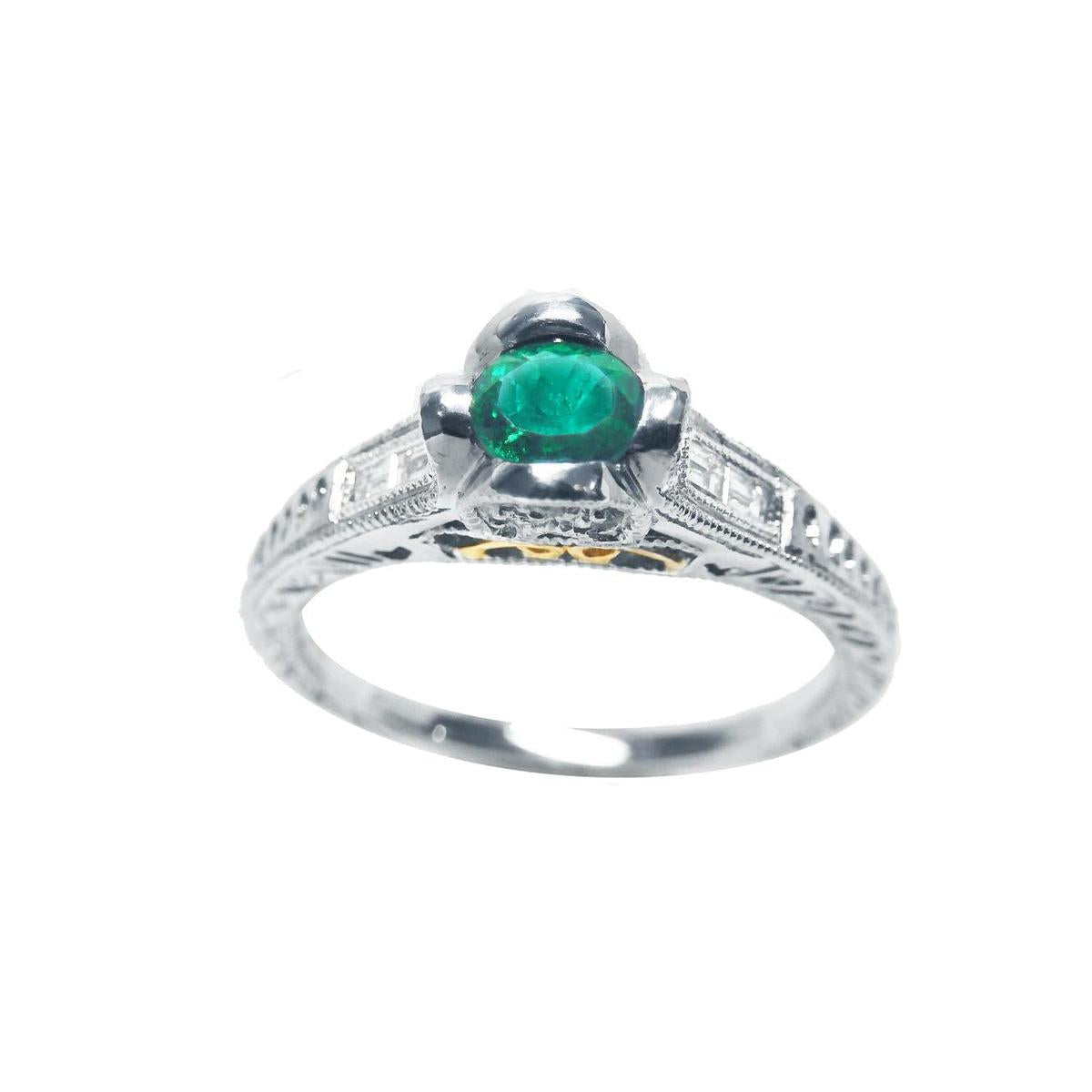 This natural oval cut colombian emerald ring in white gold displays the top and sides profile.