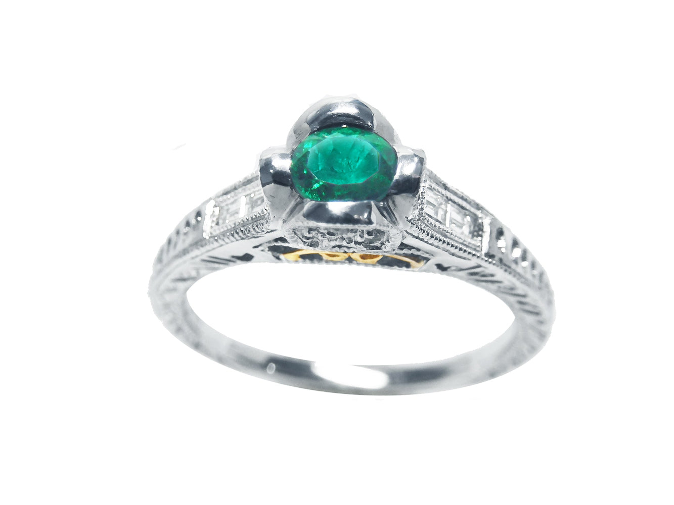 This natural oval cut colombian emerald ring in white gold displays the top and sides profile.