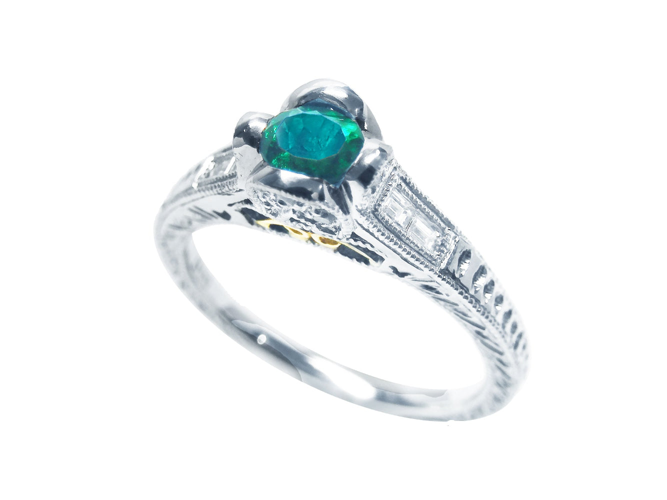 This natural oval cut colombian emerald ring displays its partial top and side angle.