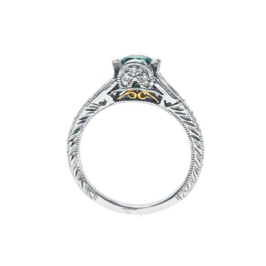 Oval-cut Colombian emerald ring in 14K white gold with diamond accents and intricate band engraving.