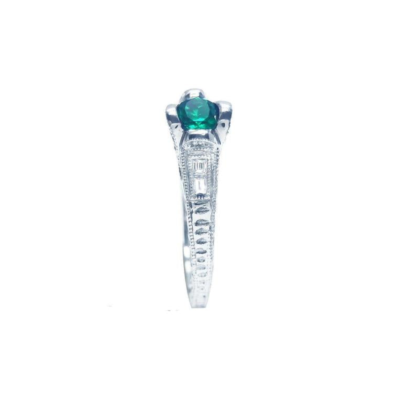 Oval-cut Colombian emerald ring in 14K white gold with baguette diamond accents.