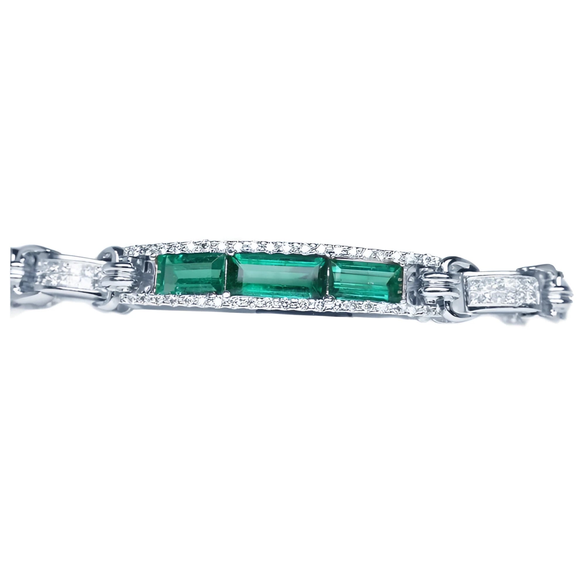 White gold bracelet with three rectangular Colombian emeralds surrounded by princess cut diamonds.