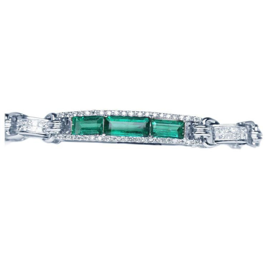 White gold bracelet with three rectangular Colombian emeralds surrounded by princess cut diamonds.