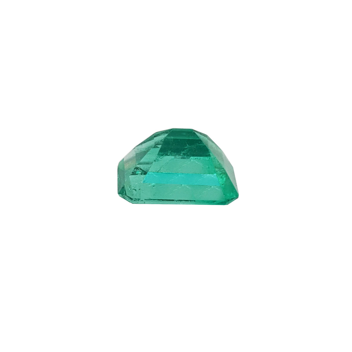 A loose colombian emerald displaying its pavilion upside down.