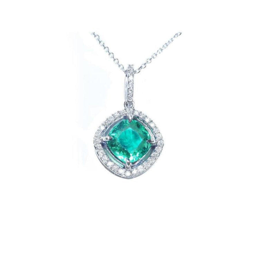 Cushion-cut Colombian emerald pendant with diamond halo in 14K white gold, on a delicate chain.