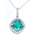 Emerald pendant with diamond halo on a white gold chain topside visible.