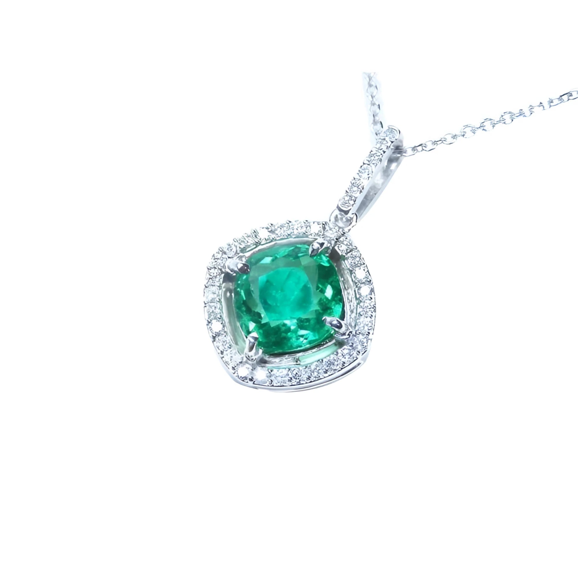 Cushion-cut Colombian emerald pendant with diamond halo in 14K white gold.