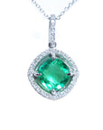 Emerald cushion cut with halo diamond pendant necklace on a topside view.
