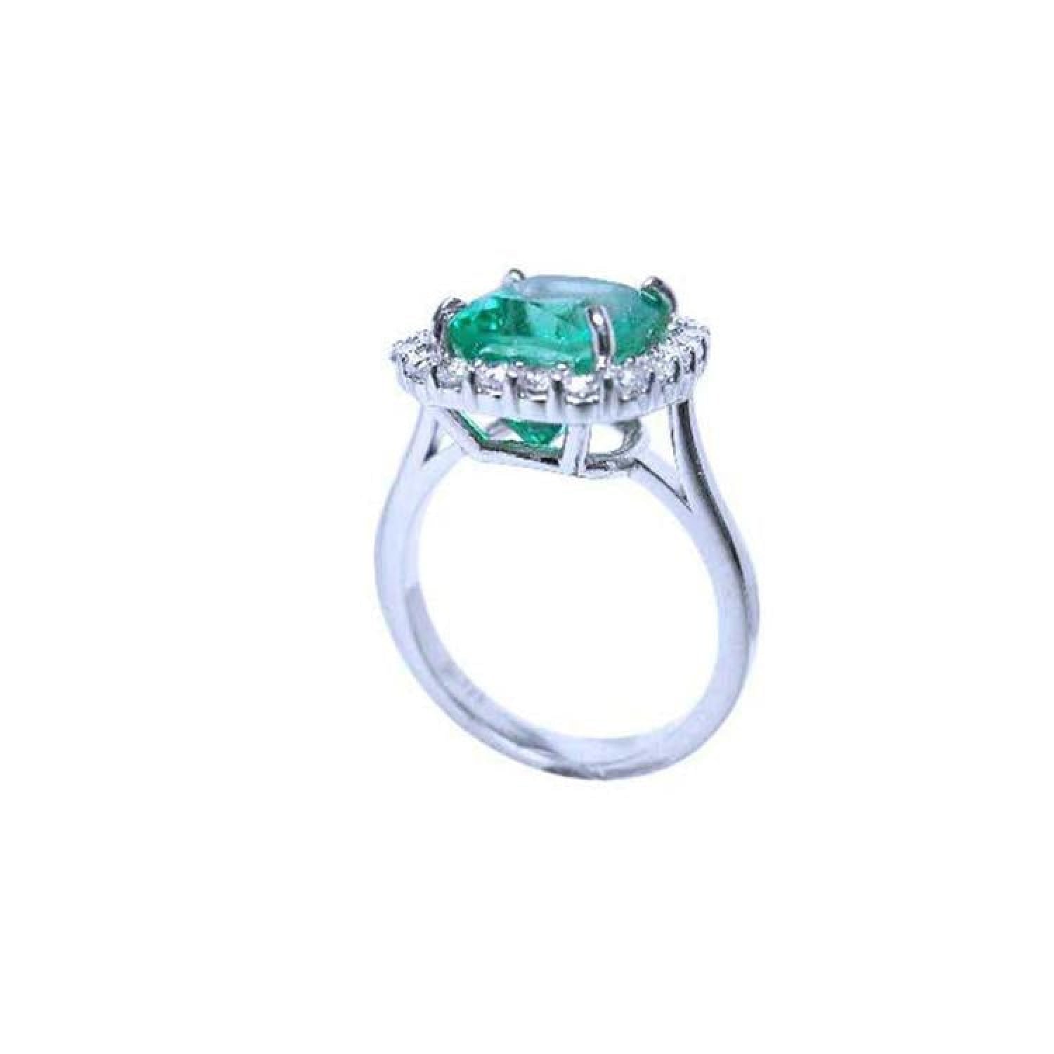 3.69 ct. cushion cut Colombian emerald engagement ring with diamond halo in 18K white gold.